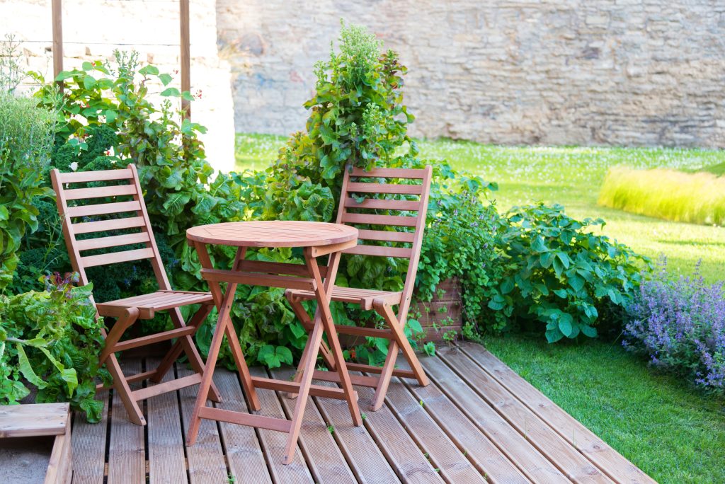 empty wood table and chairs on the terrace at summer day