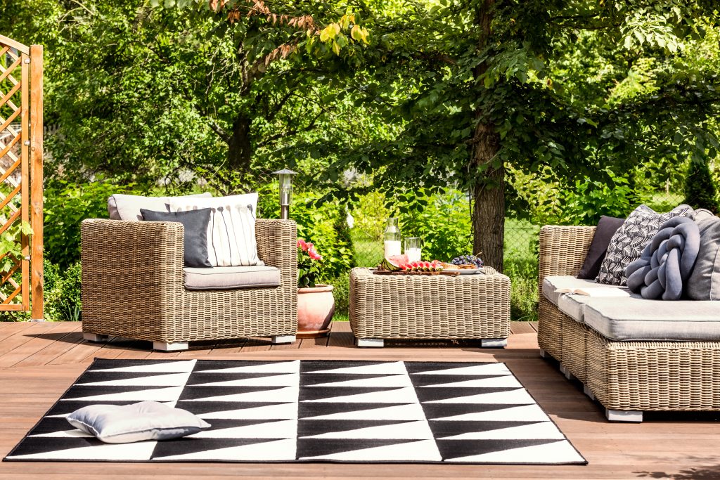 Comfy garden furniture and geometrical rug on a terrace in spa resort