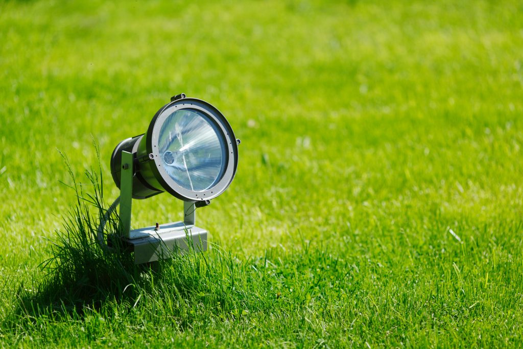 Garden lamp on background of green grass