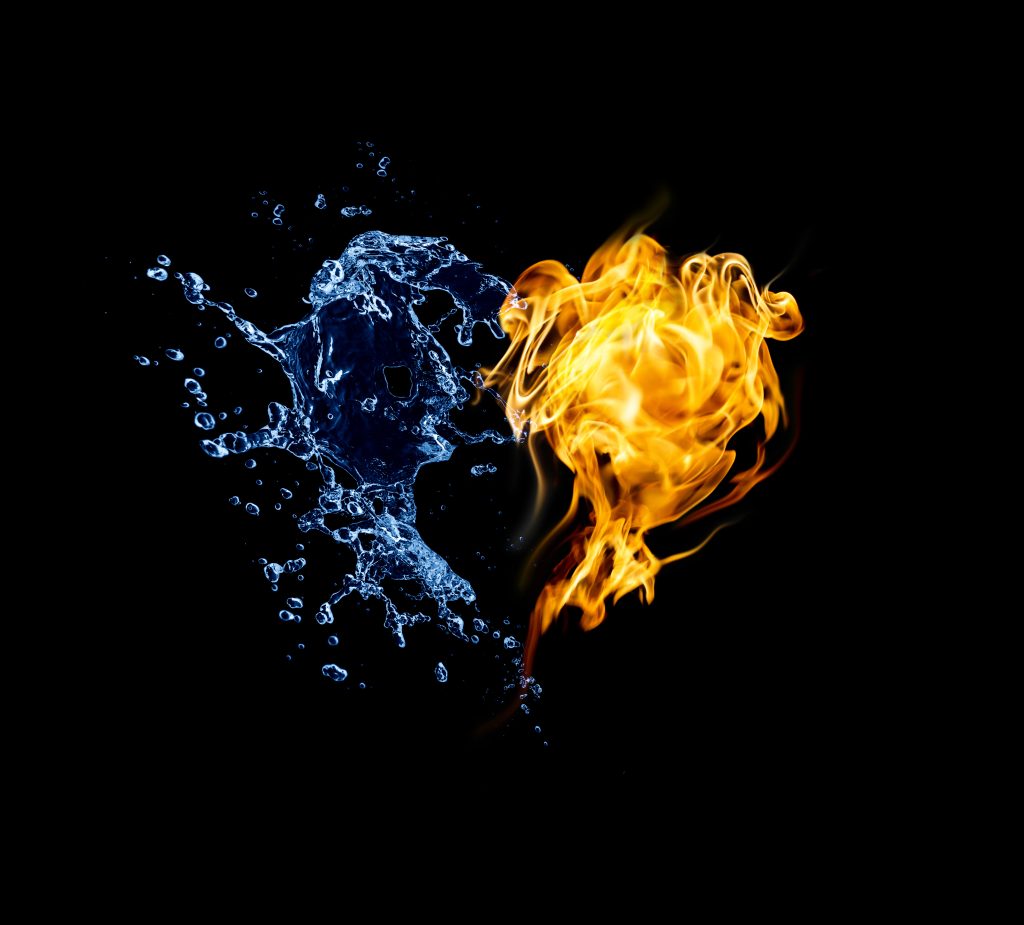 Burning heart. Heart in fire and water isolated on black background