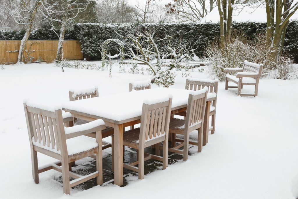 Patio garden furniture covered with snow in winter, UK