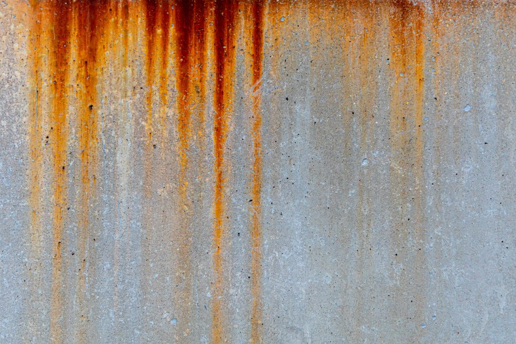 Rusty metal stain texture on concrete wall for old industry building background