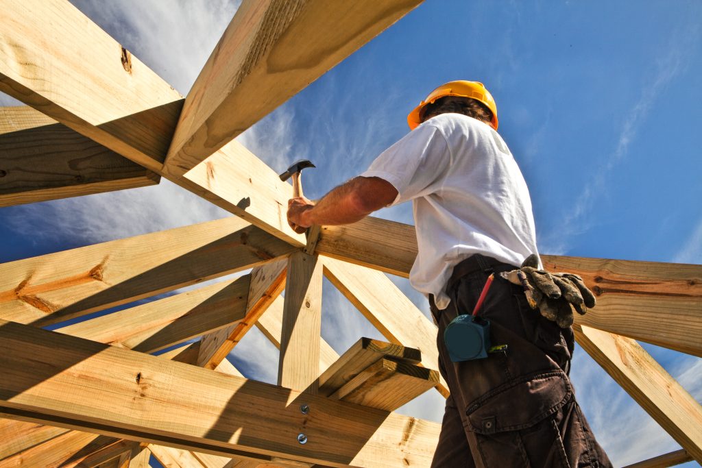 A Practical Guide to Off-Site Construction for Oak-Framed Buildings 1 roofer ,carpenter working on roof structure at construction site