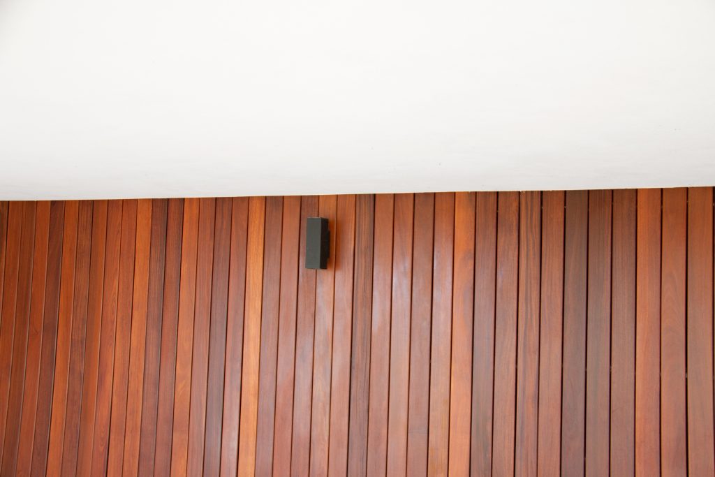 Ipe cladding on the wall, interior wood cladding design and white ceiling empty space for text